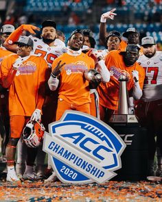 the college football team is posing for a photo with the acc championship trophy in front of them