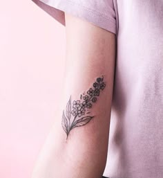 a woman's arm with a flower tattoo on the left side of her arm