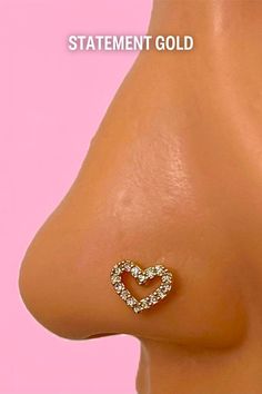 the side view of a woman's breast with a heart shaped diamond stud on it