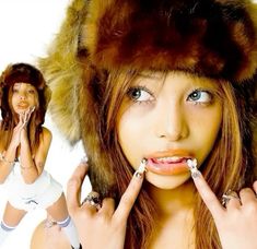 a woman with long nails and a fur hat is posing for the camera while holding her hands up to her mouth