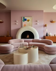 a living room filled with furniture and a fire place in the middle of the room