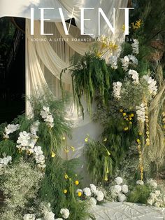 the front cover of event magazine with flowers and greenery on display at an outdoor venue