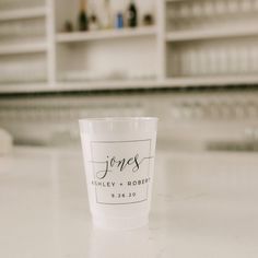 a white cup sitting on top of a counter