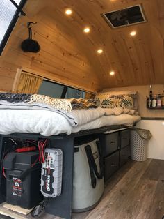 the interior of a small camper with its bed pulled out and other items in it