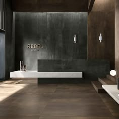 a bathroom with black walls and wooden floors