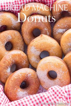 a basket filled with donuts covered in powdered sugar and topped with chocolate chips