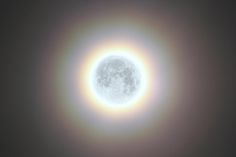 the sun's halo is seen in front of a dark sky with no clouds