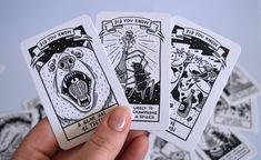 three tarot cards are held in the palm of someone's hand