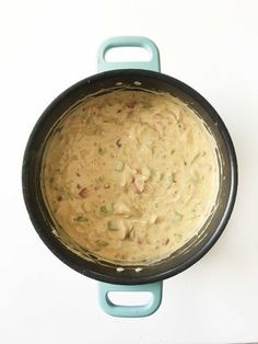 a skillet filled with food sitting on top of a counter next to a knife