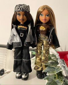 two dolls are standing next to each other