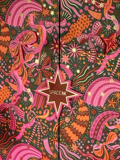 the spacen logo is on top of an intricately designed wallpaper with pink, orange and green colors