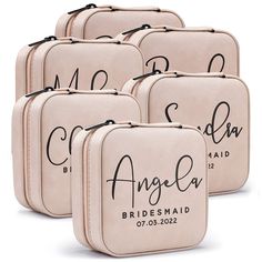 six bridesmaid cosmetic bags with the names of their wedding day written on them