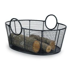 a wire basket filled with logs on top of a table