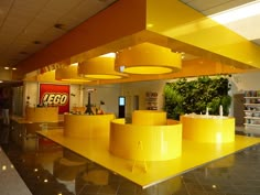 an office lobby with yellow lighting and plants