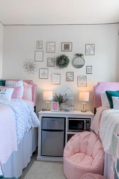 a bedroom with two beds, a chair and pictures on the wall