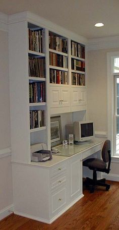 a home office with bookshelves, desk and computer