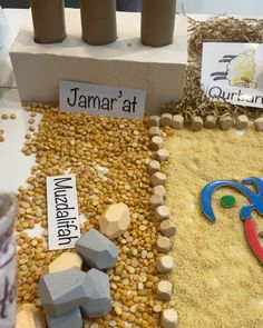 there are some rocks and sand in front of each other on the table with name tags