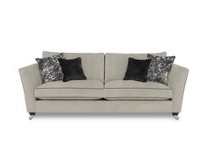 a beige couch with black and white pillows