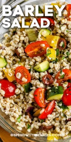 barley salad with tomatoes, cucumbers and other vegetables in a glass bowl