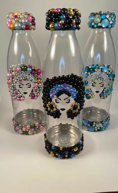 three glass vases with beaded designs on them