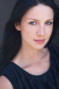 a woman with long black hair and blue eyes