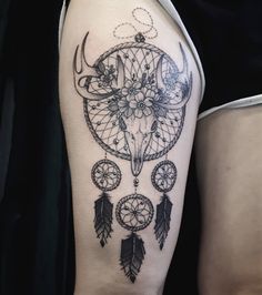 a black and white photo of a woman's arm with a tattoo on it