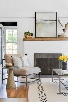 a living room filled with furniture and a painting on the wall above it's windows