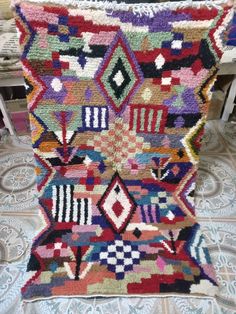 a multicolored rug is sitting on the floor