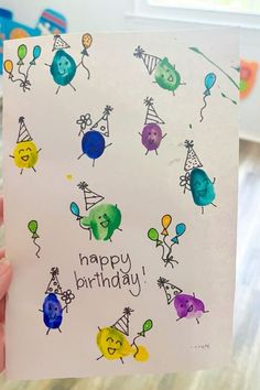 someone holding up a birthday card in their hand