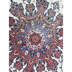 an intricately designed rug is shown in red, blue and green colors on white ground