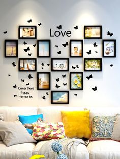 a living room filled with furniture and lots of pictures on the wall above it's love