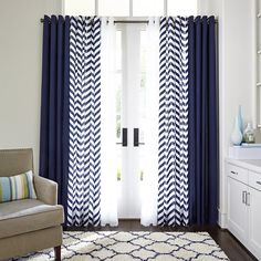 a living room with blue and white curtains