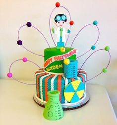 a birthday cake decorated with an image of a boy on top and colorful decorations around it