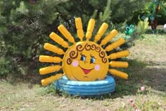 an inflatable sun sculpture sitting on top of a blue ringed pool float