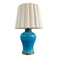 a blue table lamp with a white shade