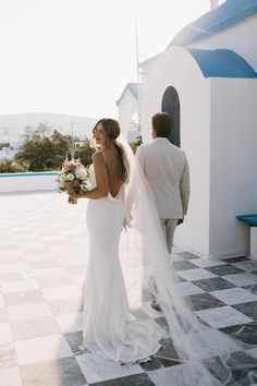 a bride and groom walking down the aisle