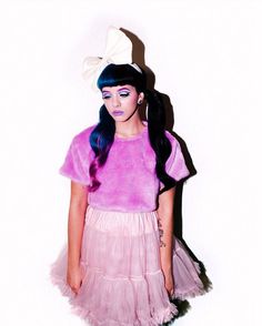 a girl with blue hair wearing a pink dress