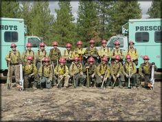 a group of fire fighters posing for a photo