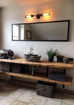 a bathroom with two sinks and mirrors on the wall