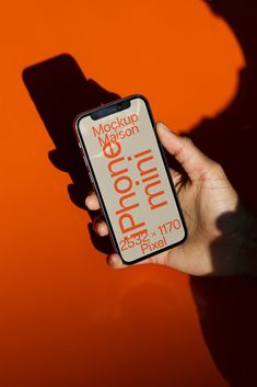 a person holding an iphone in their hand with the text mockup mason on it