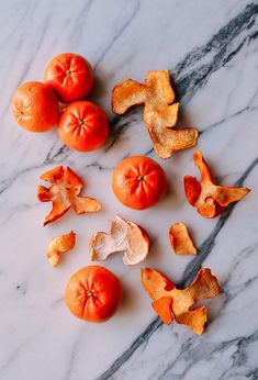 peeled oranges and peels on a marble surface