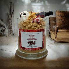 a jar filled with lots of food sitting on top of a table next to a pile of books