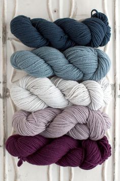 six skeins of yarn in various colors