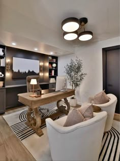 a living room with two white chairs and a wooden table in the middle of it