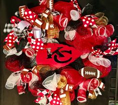 a wreath with footballs and bows on it