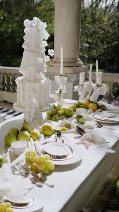 the table is set with white plates and silverware