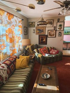 a living room filled with furniture and pictures on the wall