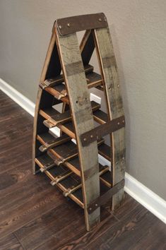 a wine rack made out of wooden planks on top of a hard wood floor