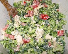 broccoli salad with tomatoes and cauliflower in a bowl