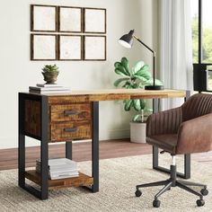 an office with a desk, chair and potted plant on the floor in front of it